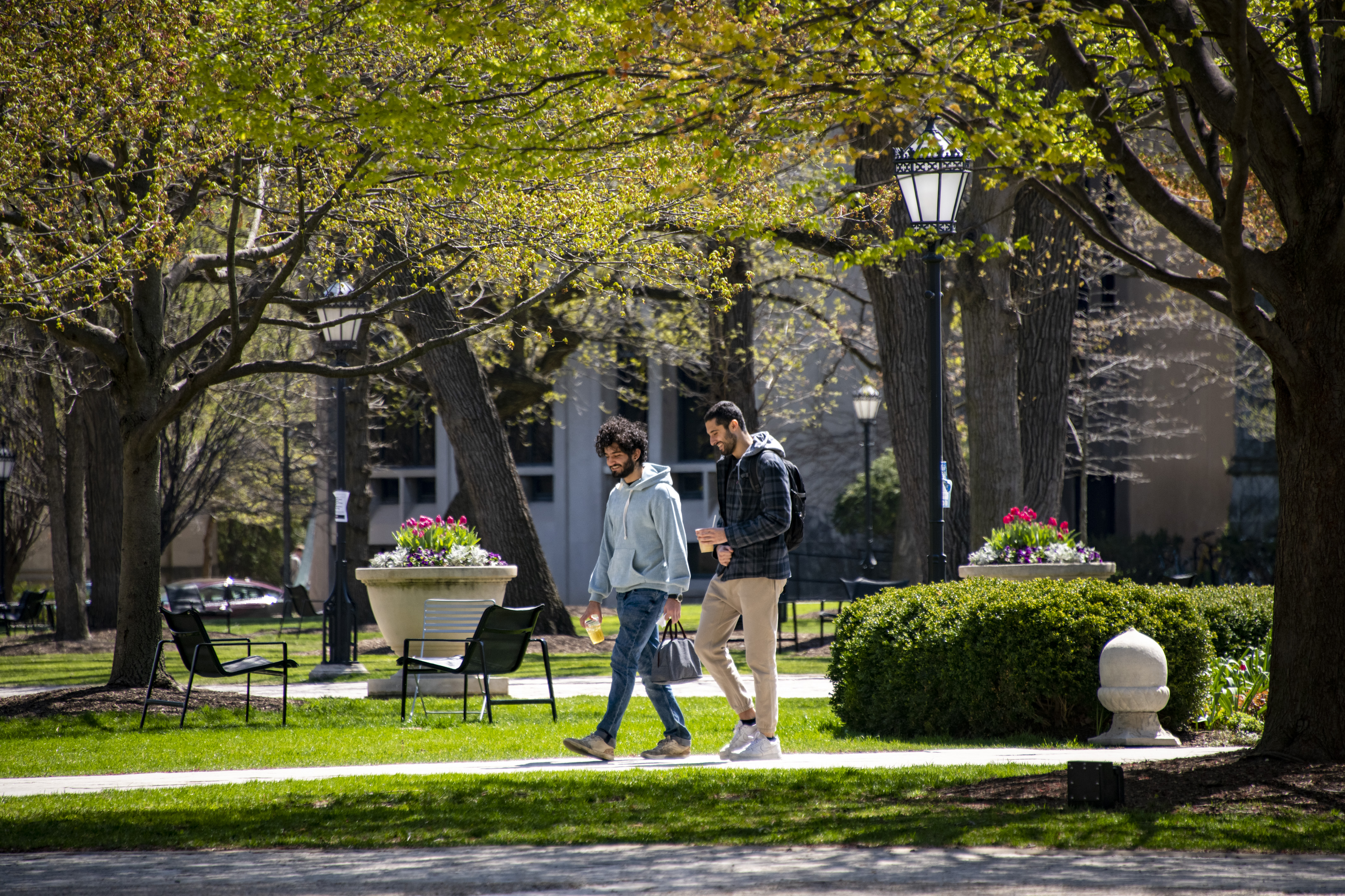 Students walk on campus during a warm spring day