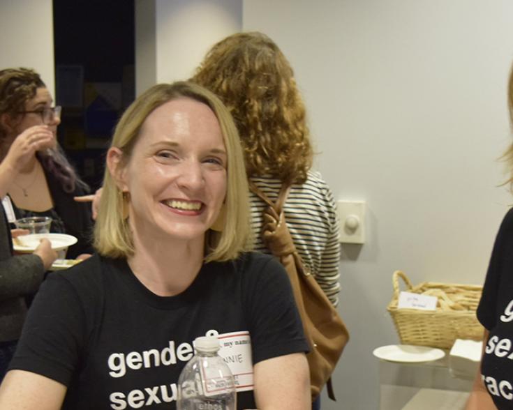 Three people smiling at camera.