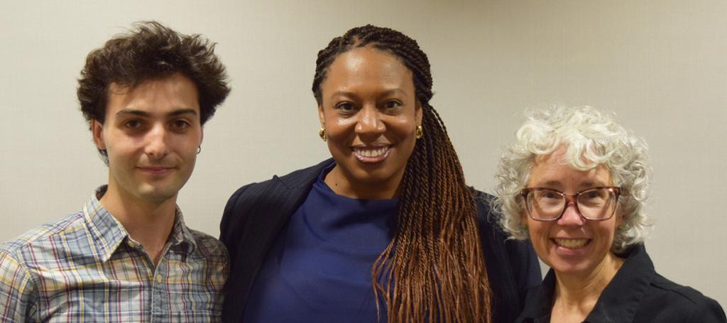 Three poeple smiling at the camera.