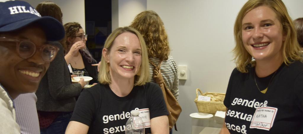 Three people smiling at camera.